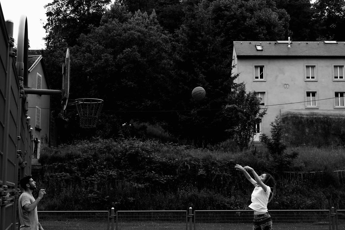 person man and girl playing basketball black-and-white