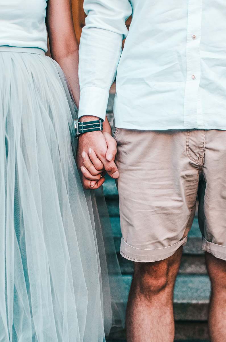 people man and woman holding hands while standing hand