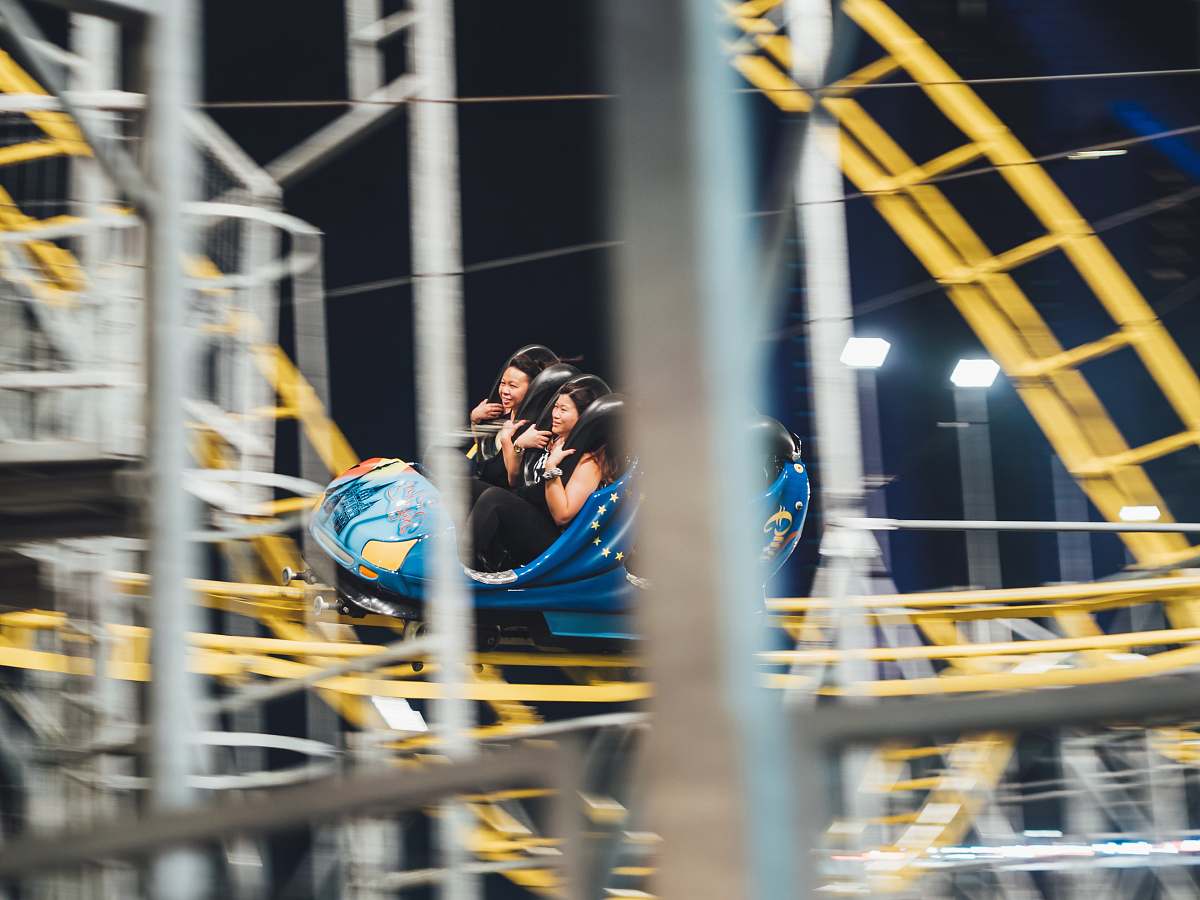 person man and woman on roller coaster people