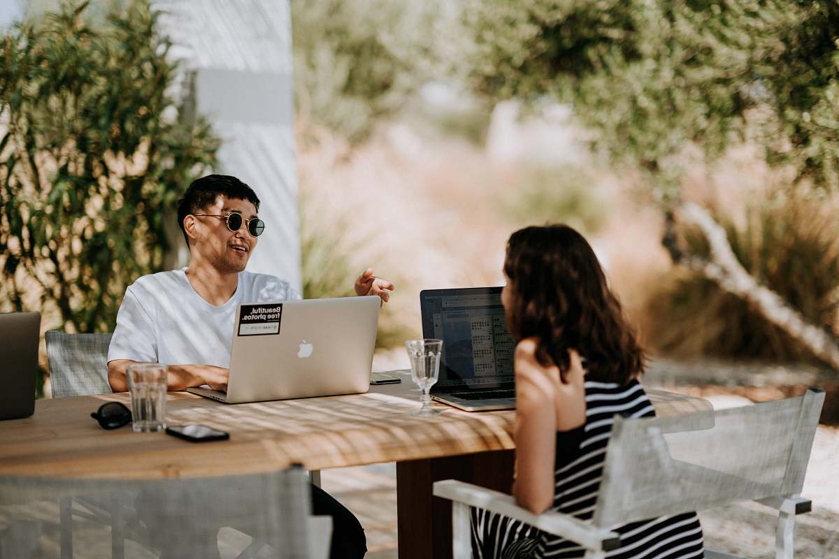 person man and woman sitting outdoors people
