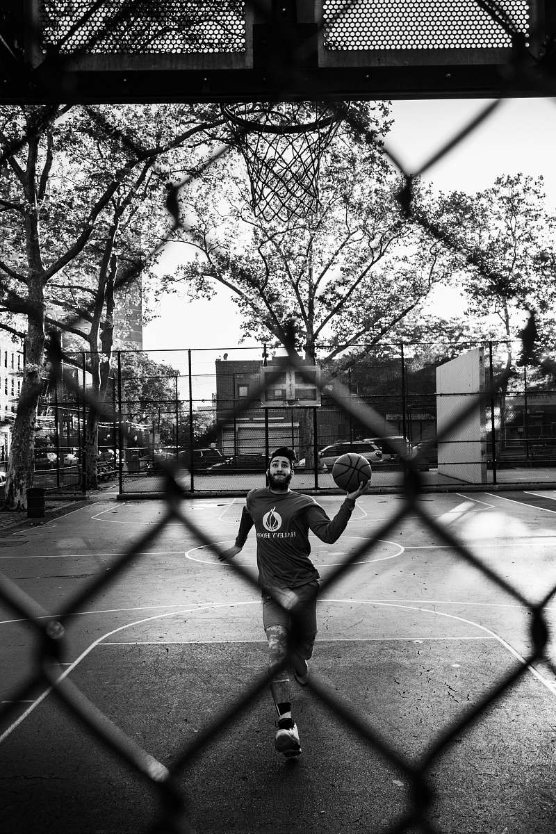 person man holding ball through ring\ black-and-white