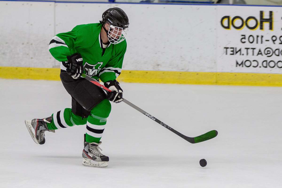 person man in hockey gear playing hockey apparel