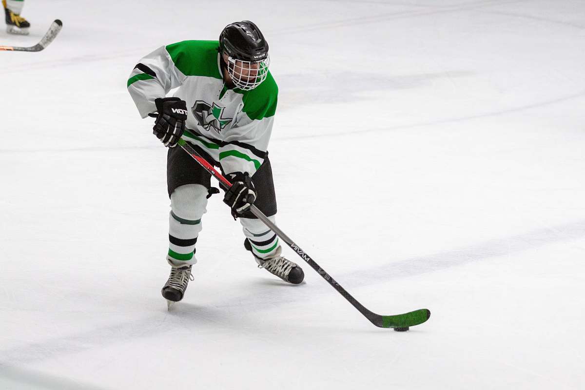 person man in yellow and green ice hockey jersey t hockey