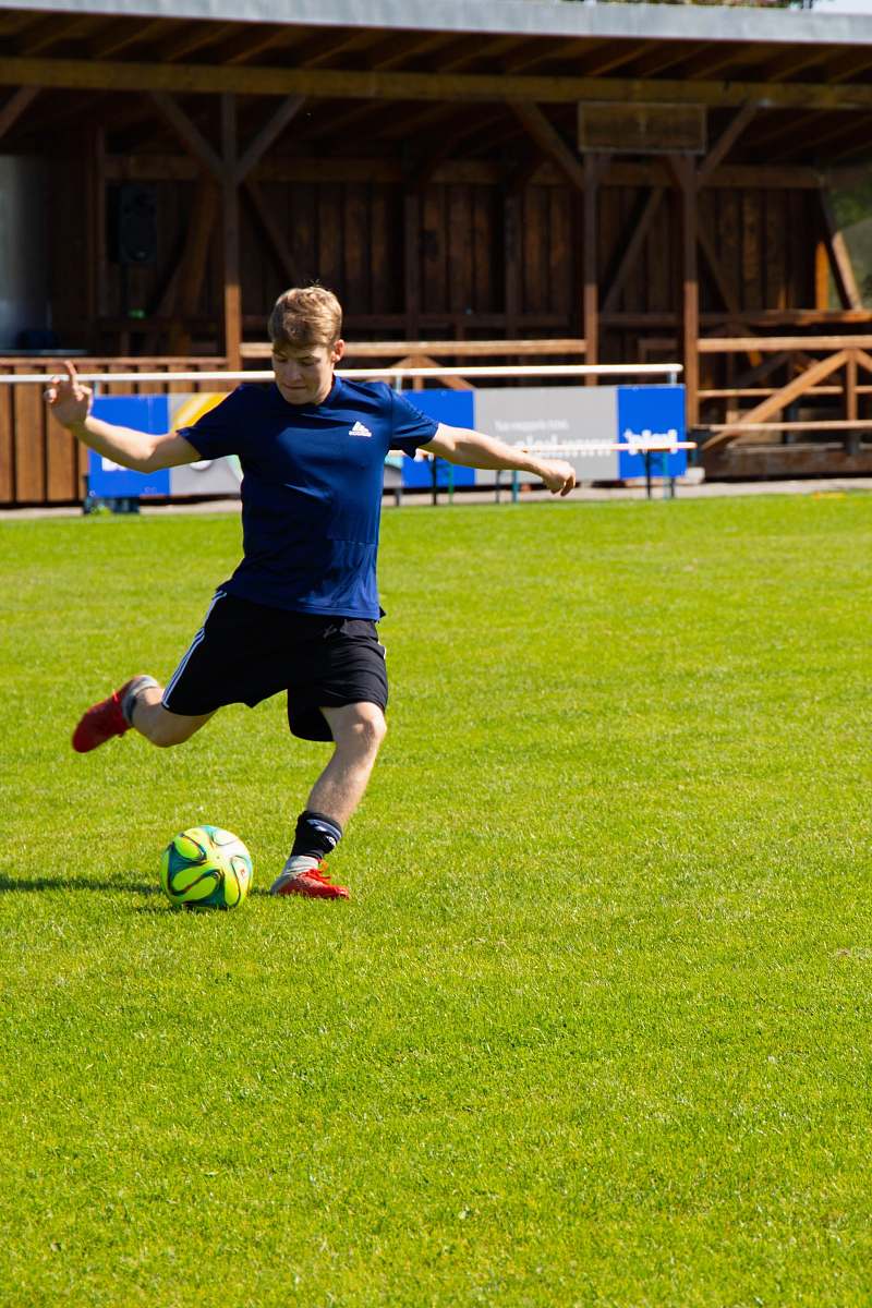 people man kicking soccer ball person