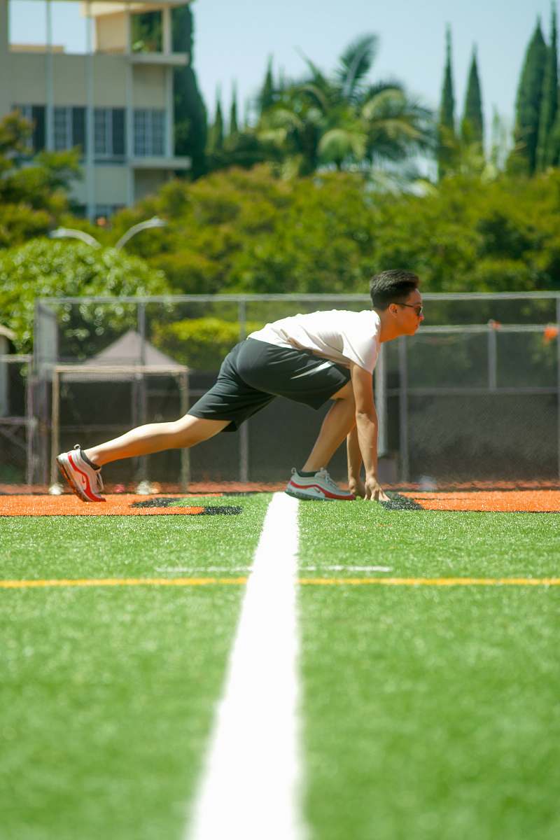 people man on grass getting ready to run during day person