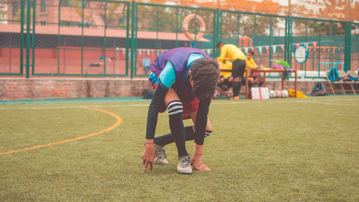 person man on playing field during daytime sports