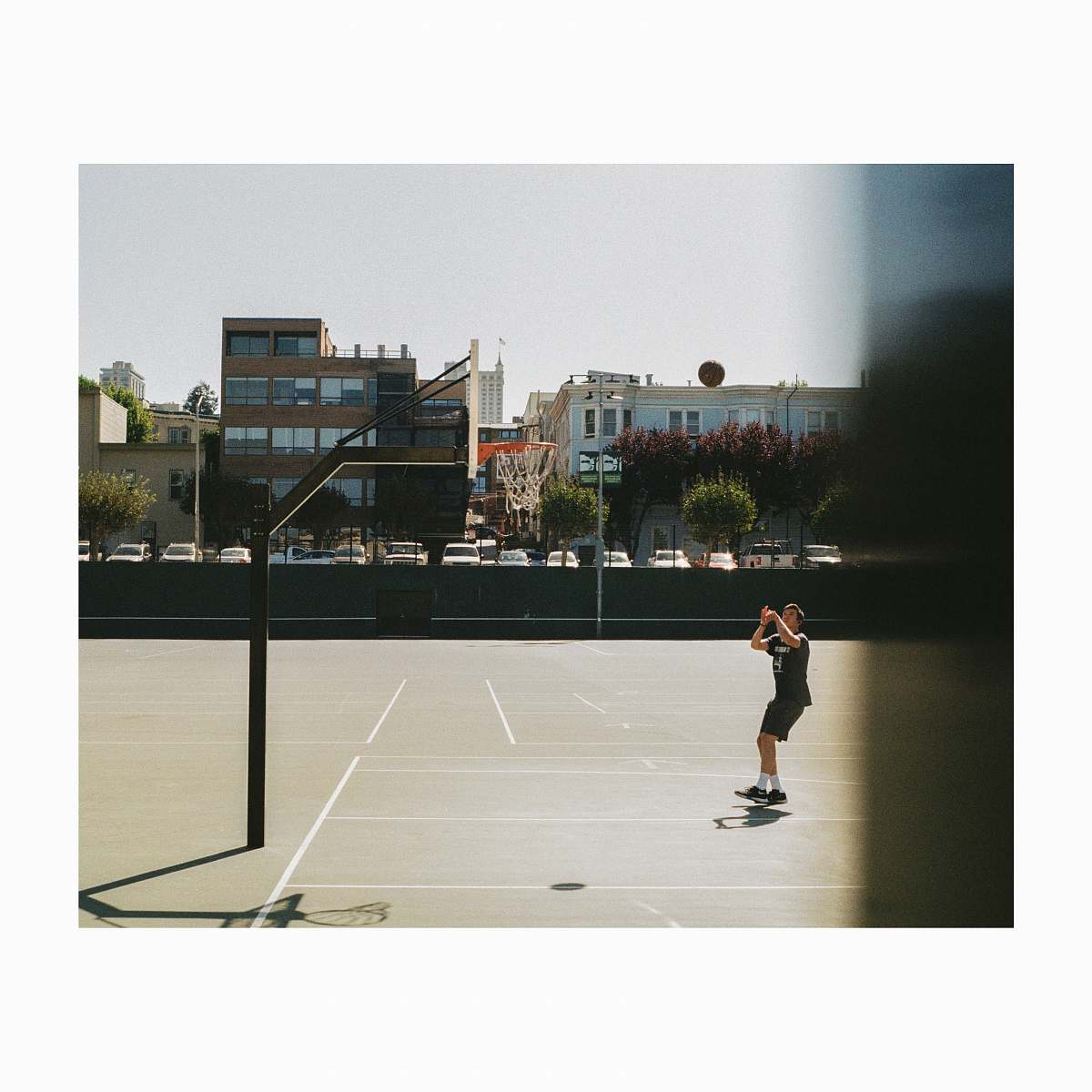 people man playing basketball on court during daytime person