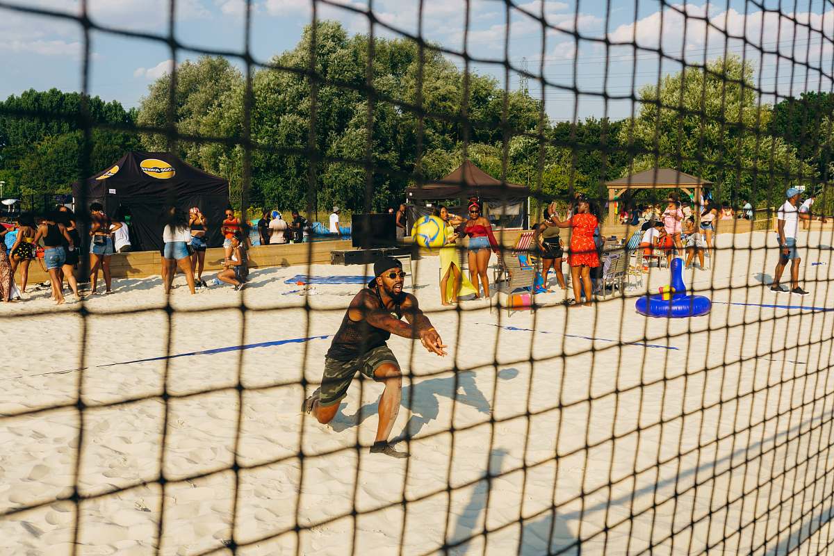 person man playing beach volleyball hockey
