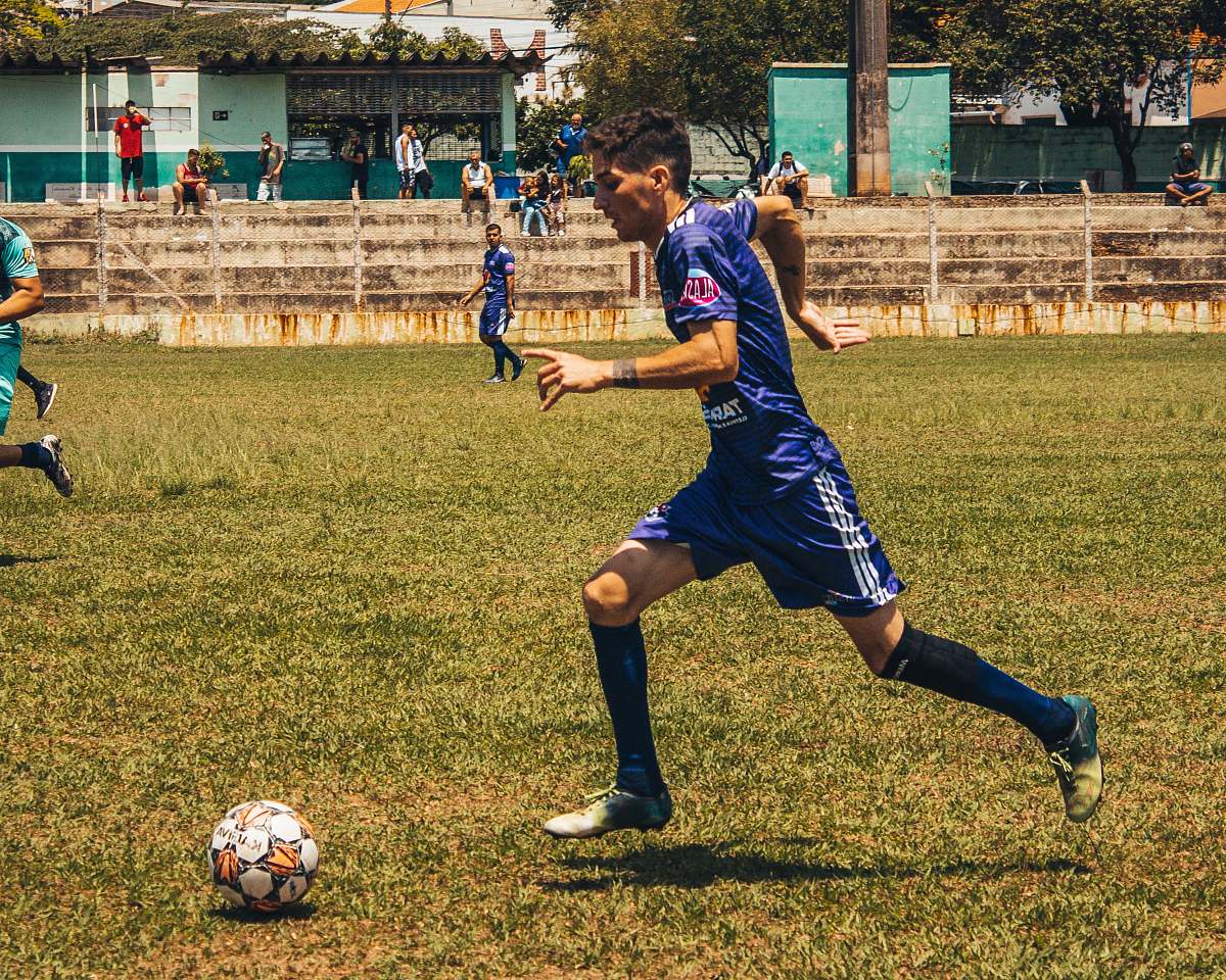 person man playing soccer on field people