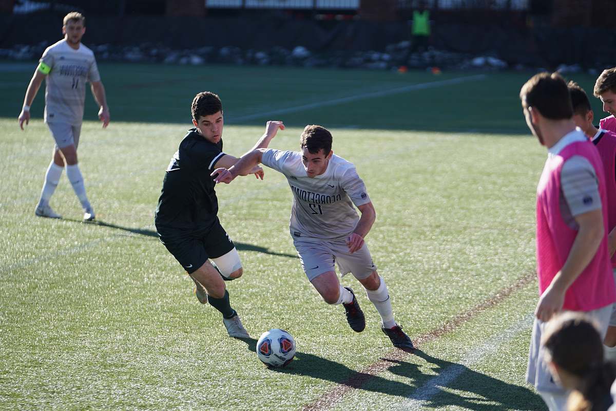 person man playing soccer on the field people