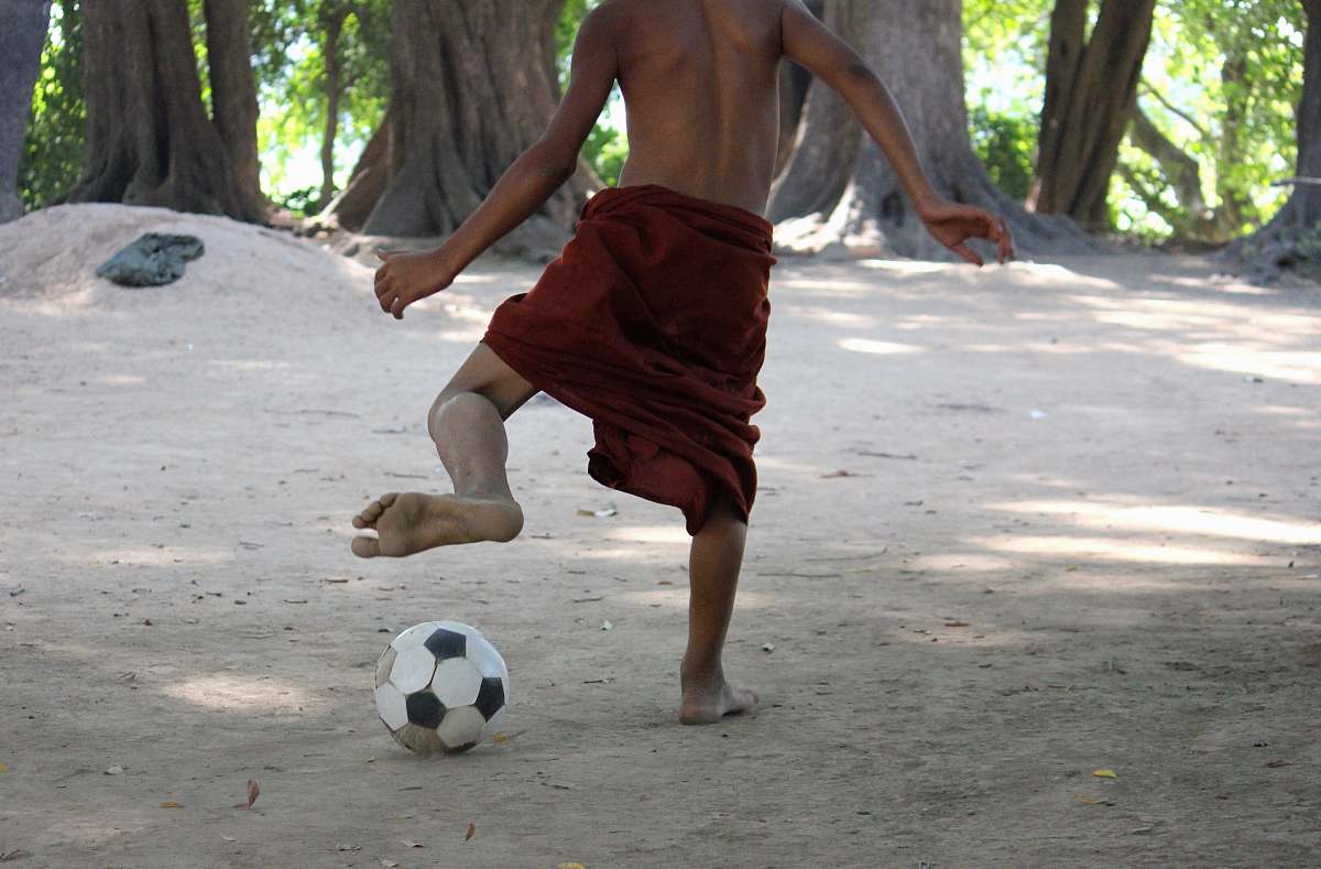 person man playing with soccer ball team