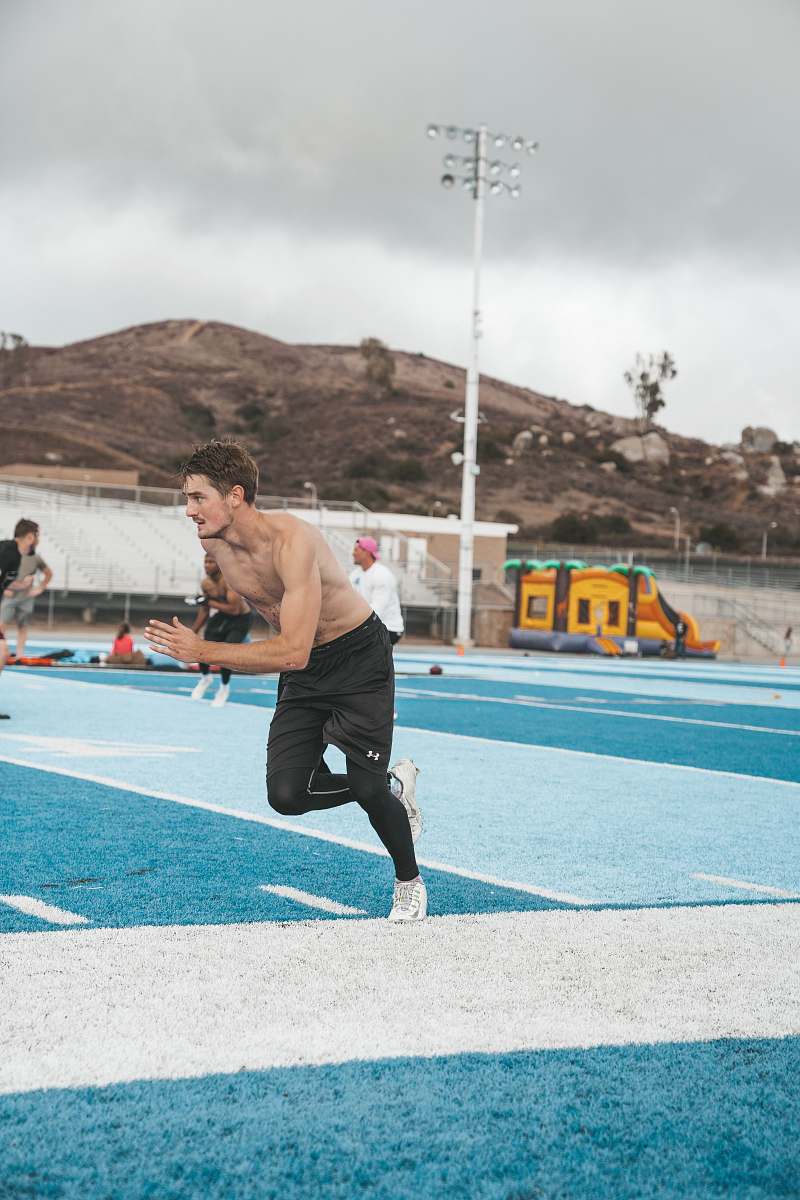 person man running at the field sports