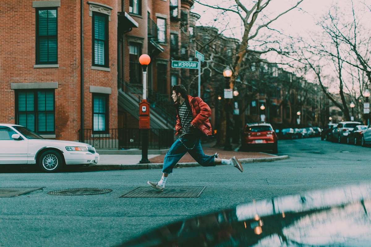 person man running on street automobile