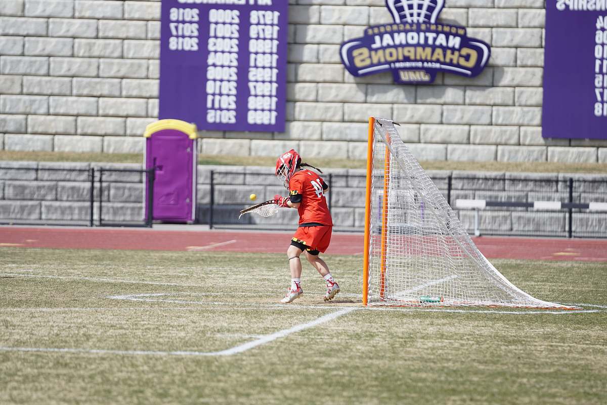 person man standing in front of goalie net people