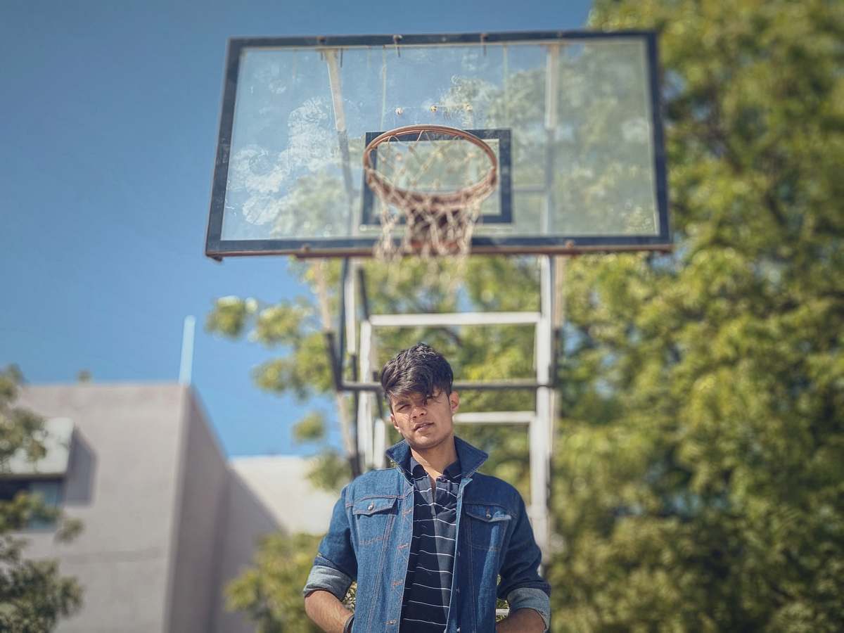 person man standing near basketball system during daytime people