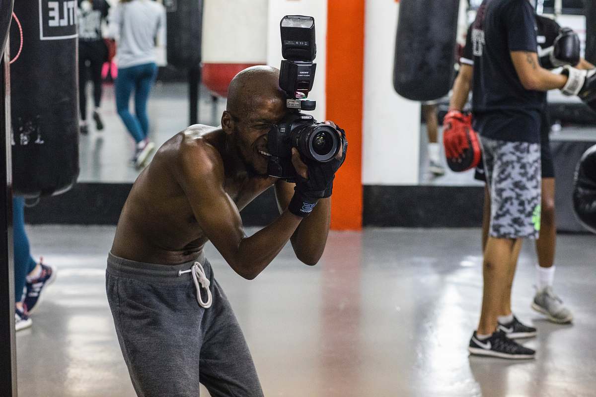 person man taking picture while using DSLR camera shoe