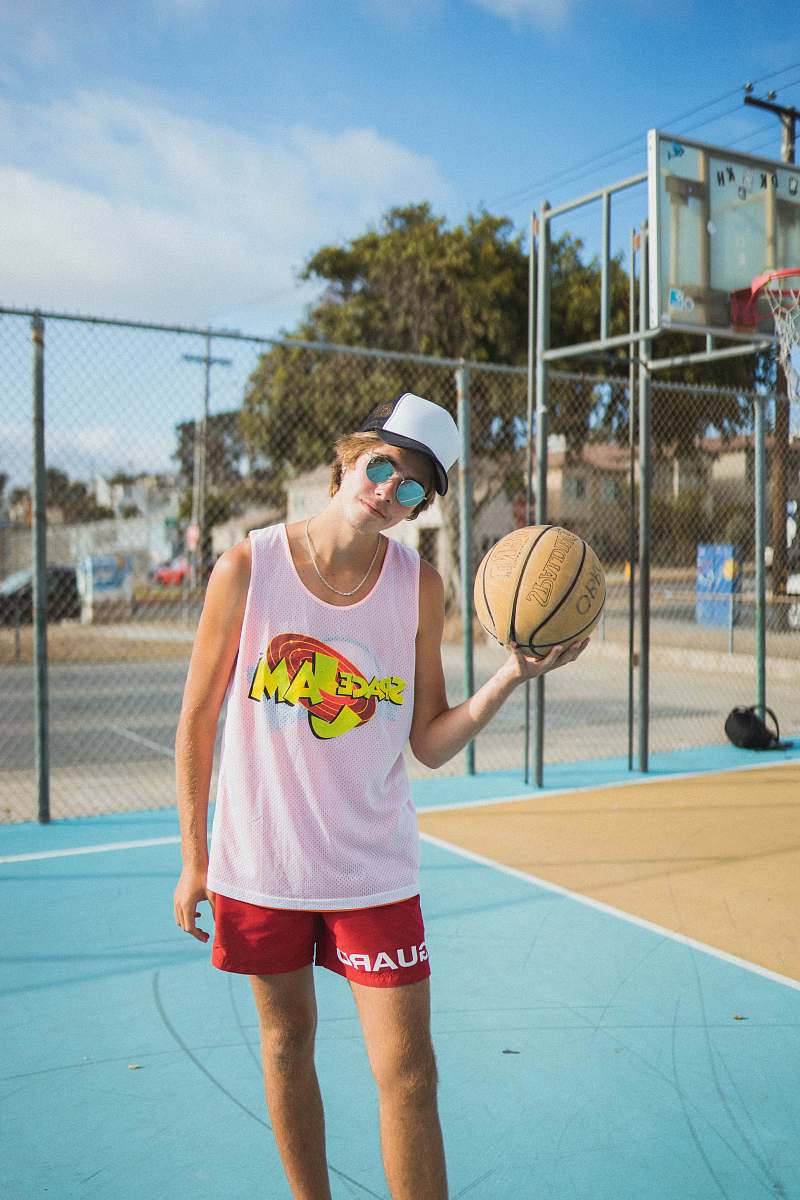 person man wearing white tank top and red shorts accessories