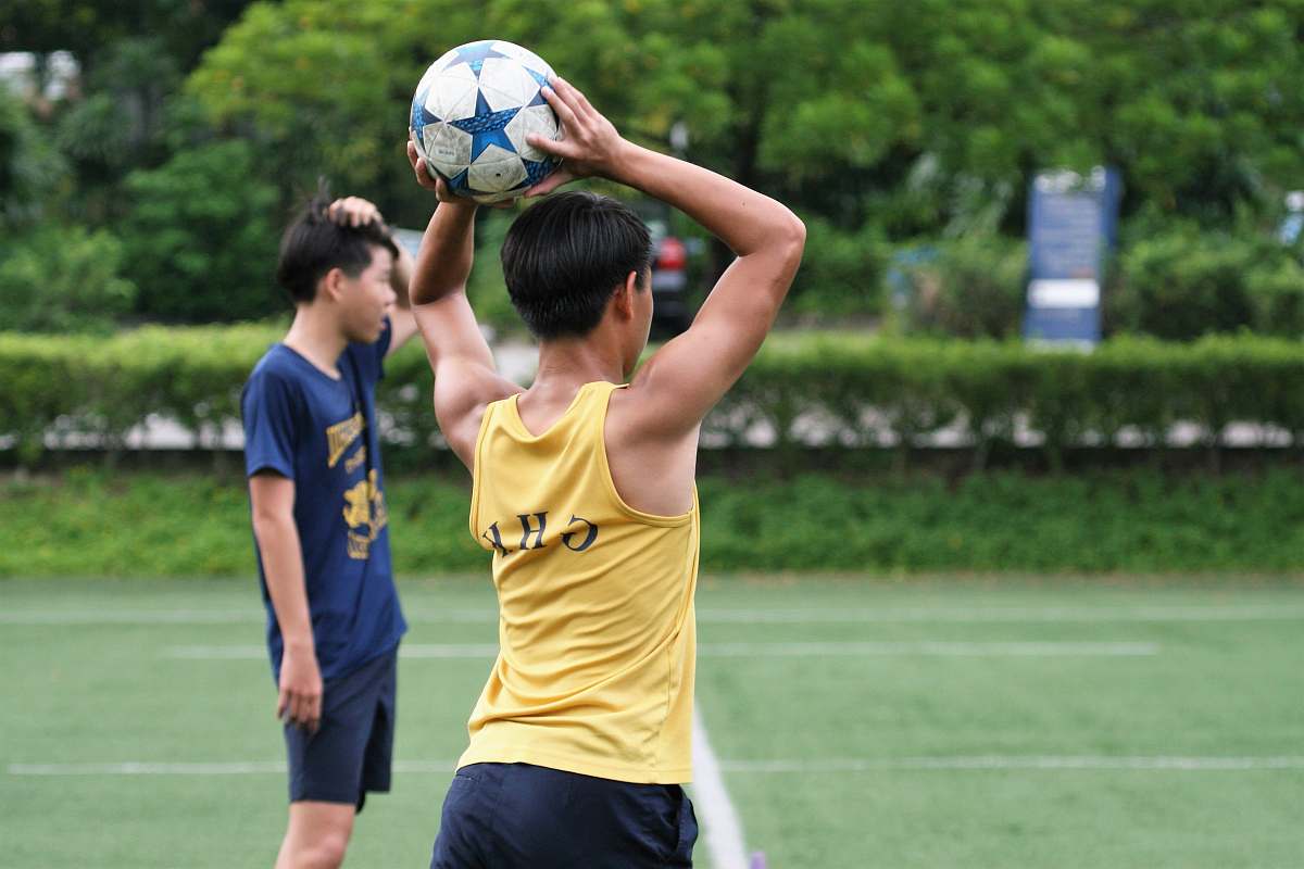 person man wearing yellow tank top holding soccer ball people