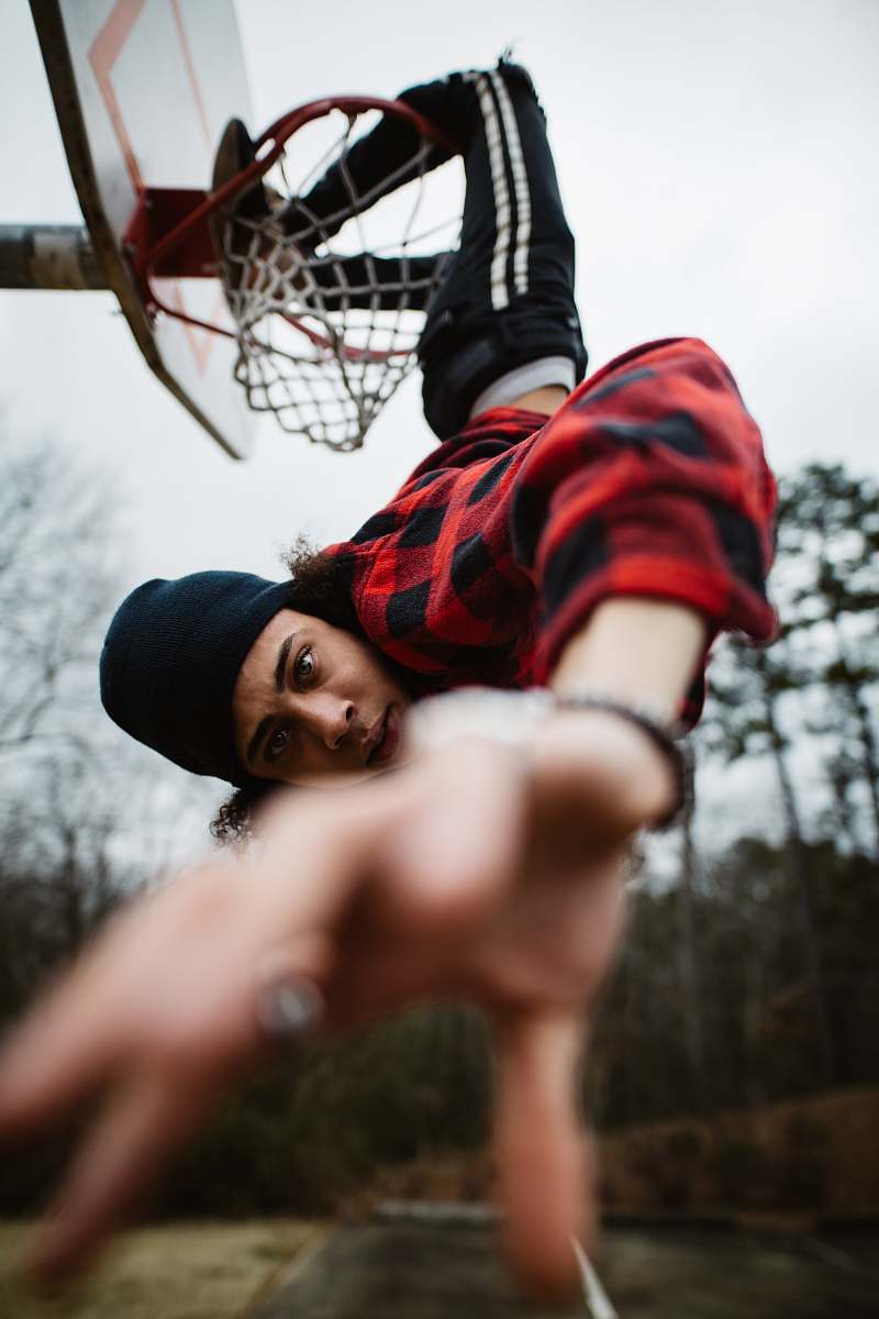 person man with legs on basketball ring during daytime people