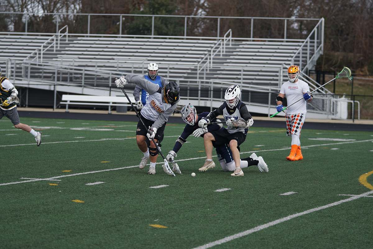 person men playing lacrosse in field apparel