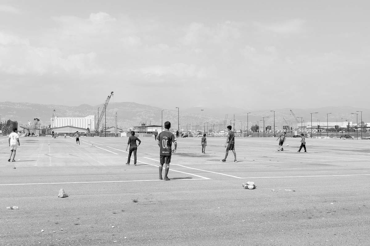 person men playing on field photo black-and-white