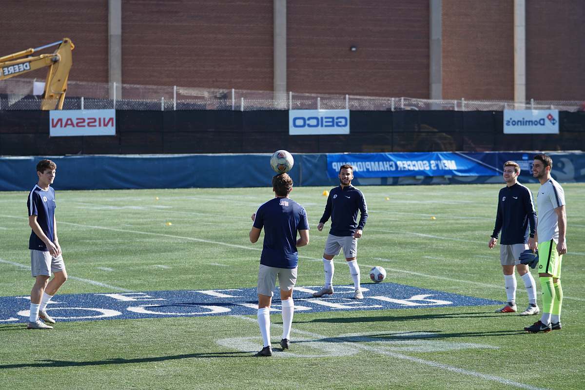 person men playing soccer during daytime people