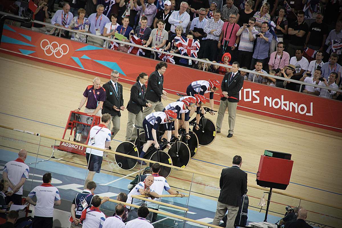 person men riding bicycles on starting line at track people