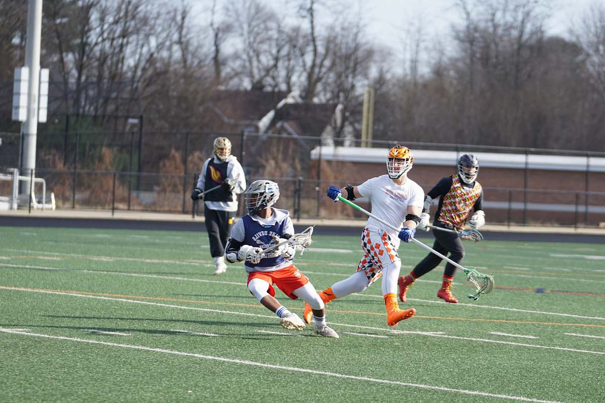 person people playing lacrosse at field apparel