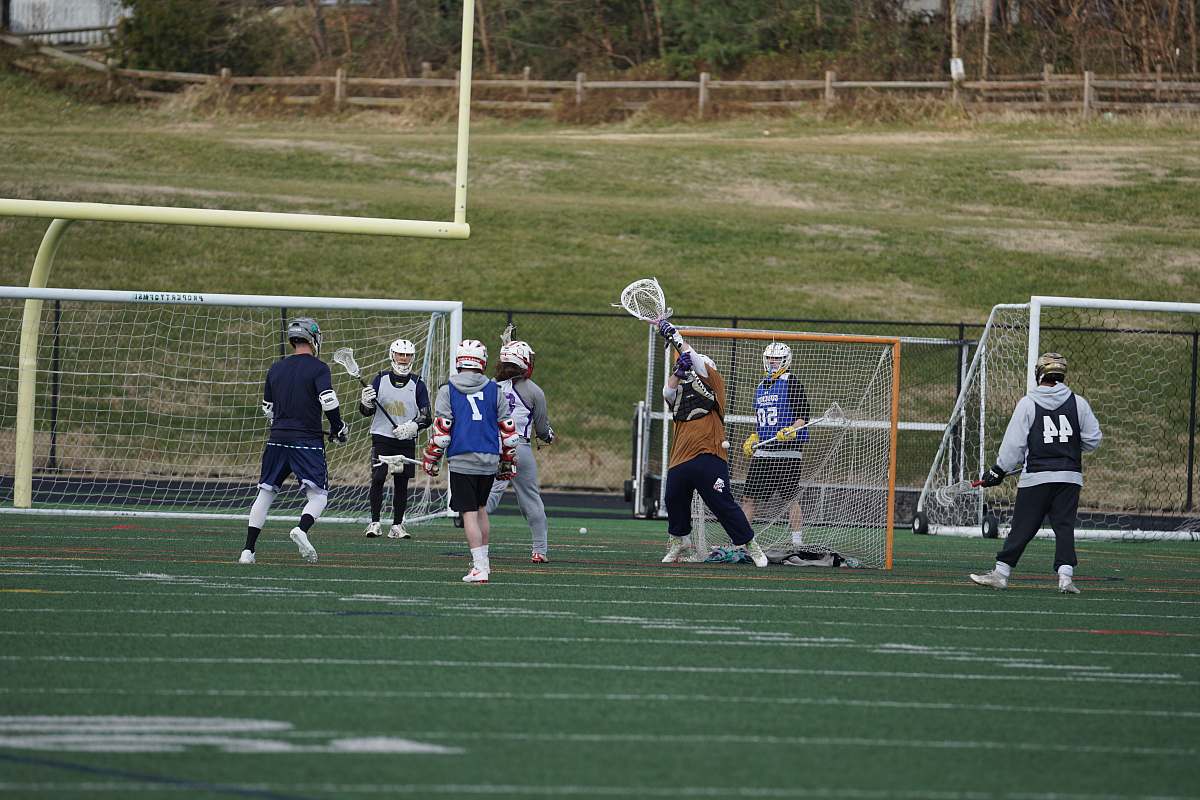 person people playing lacrosse game on field people