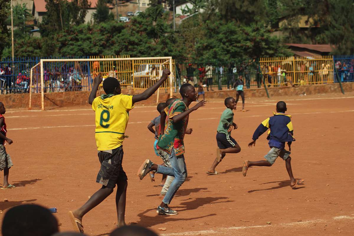 person people running on soccer field during daytime sport