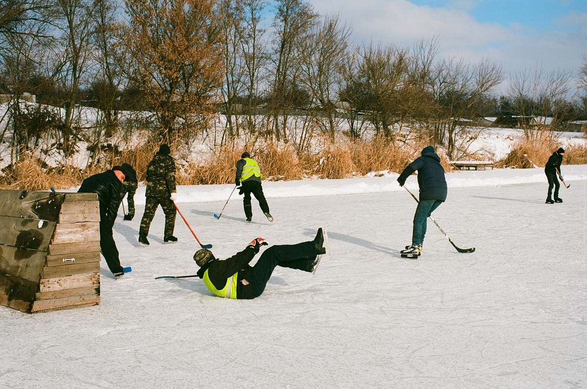 person people skating on field hockey
