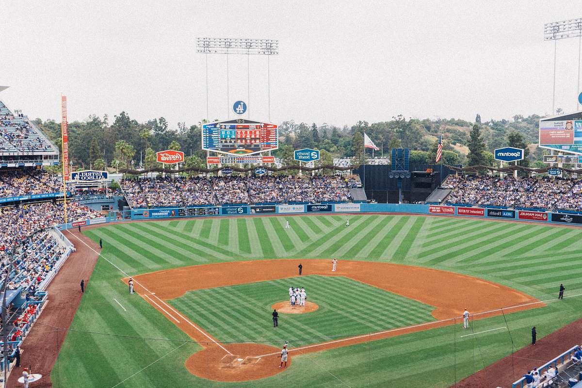 person people watching game on stadium during daytime building