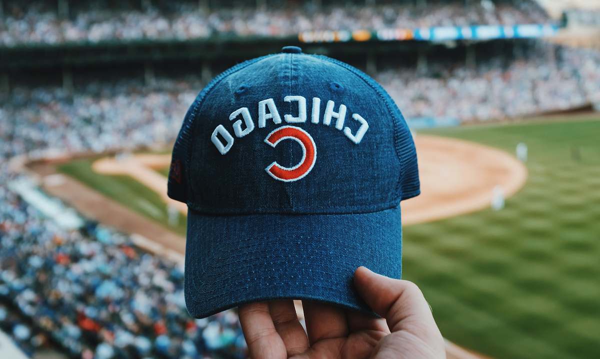 person person holding blue Chicago Cubs cap people