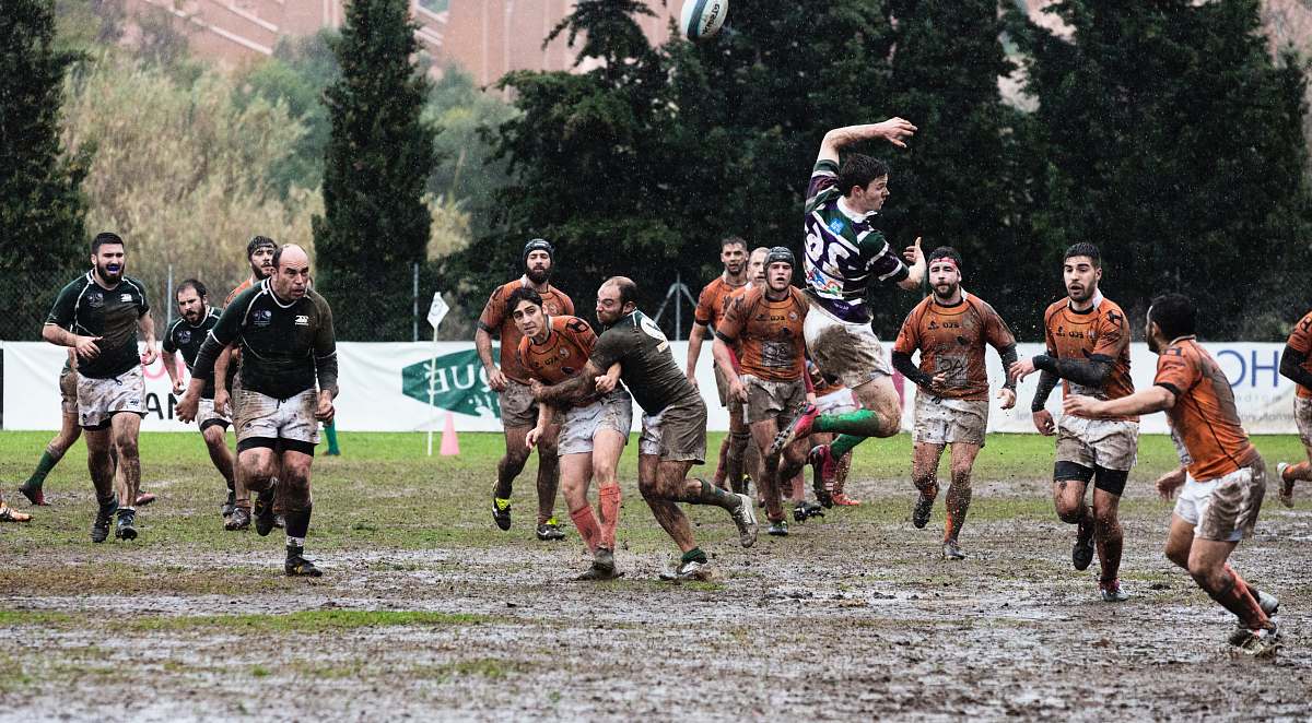 person person wearing black jersey jumps across people wearing orange jerseys people