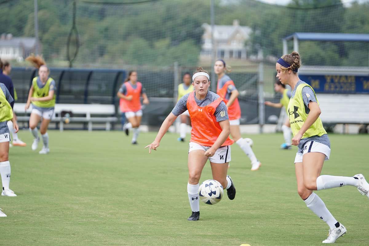 person photography of women playing soccer during daytime people