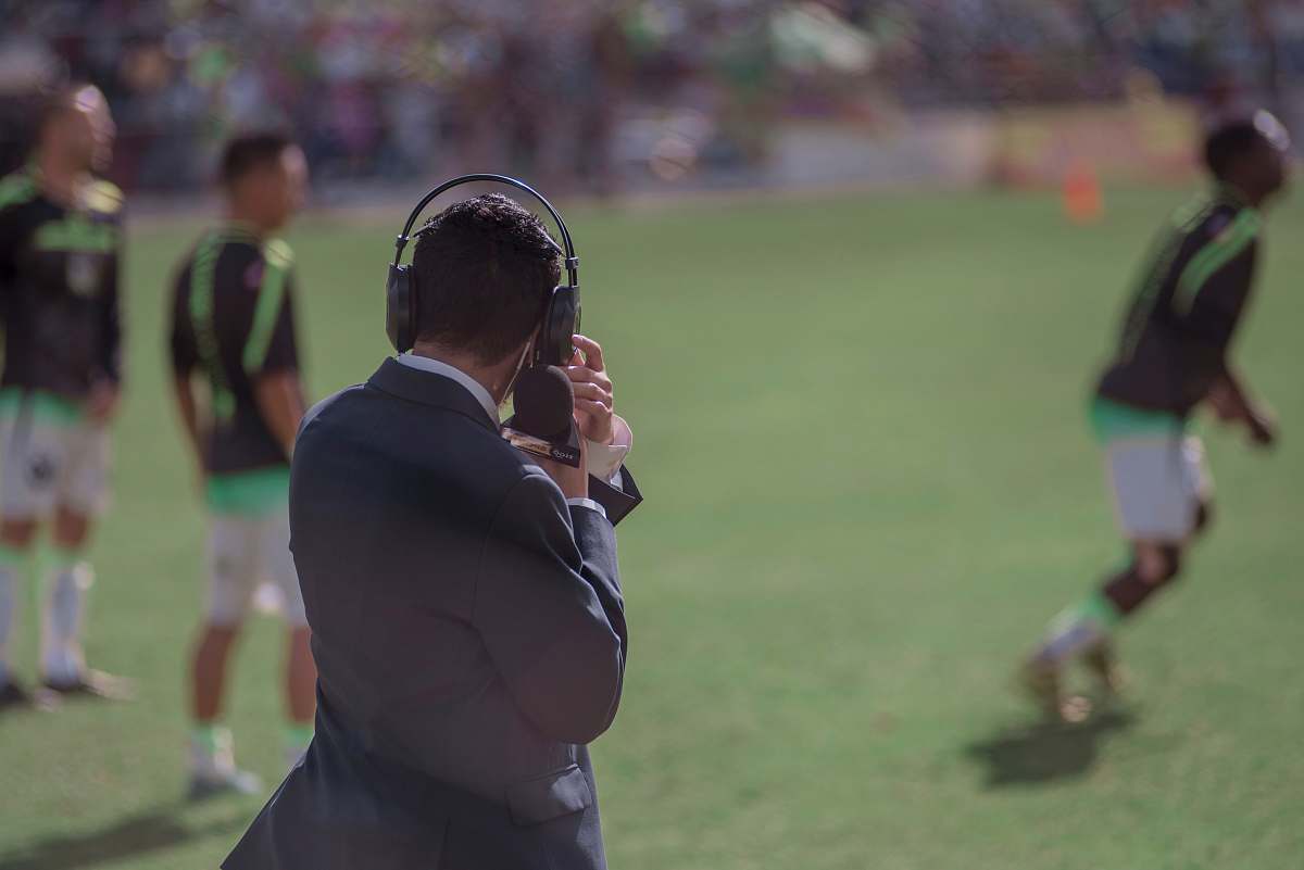 person selective focus photography of man using headphones near athletes people