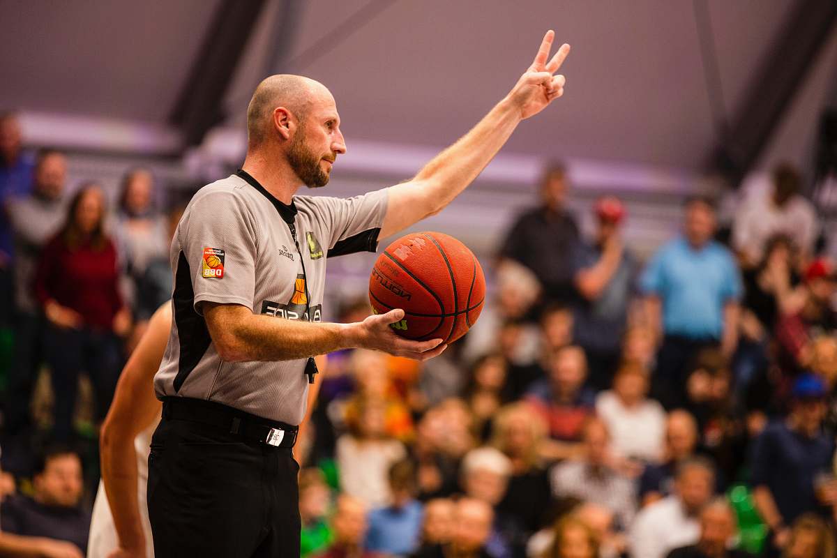 person shallow focus photo of man holding basketball people