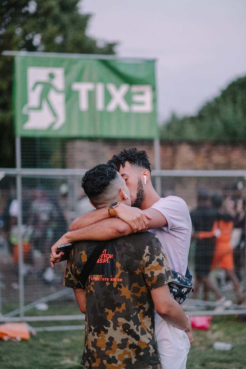 person shallow focus photo of two men kissing shorts