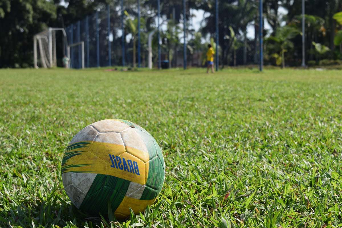 person soccer ball on grass ball
