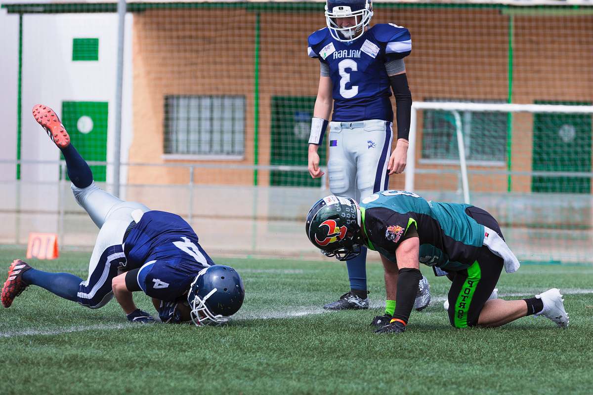 person three American football standing on grass field people