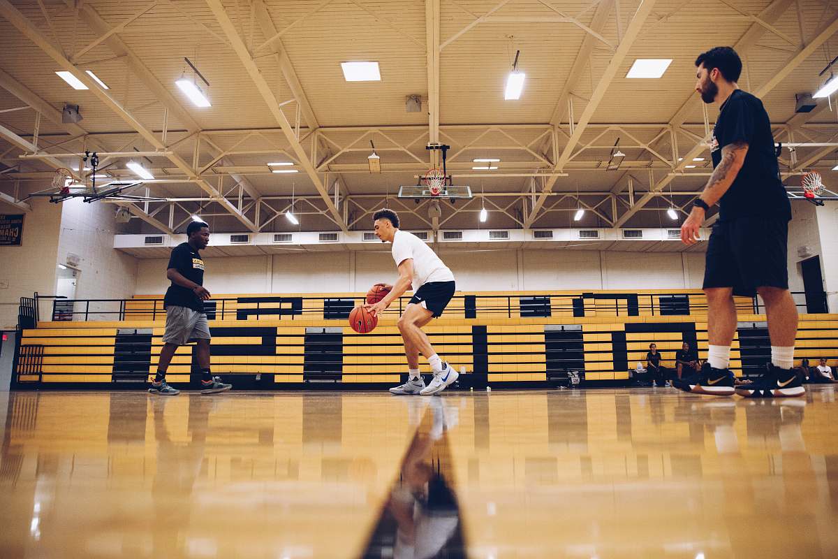 person three men playing basketball people