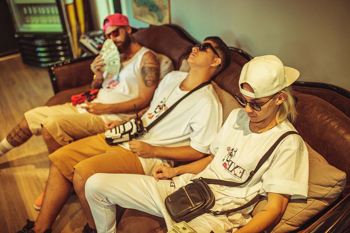 apparel three men sitting on sofa clothing