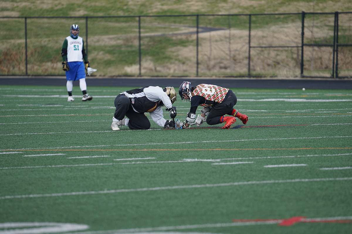 person three people on green sports field during daytime american football