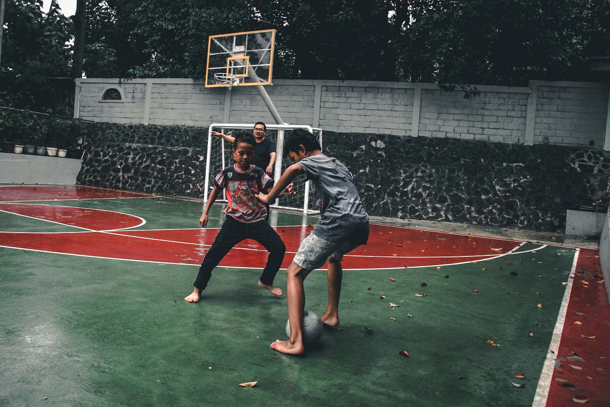 person two boys playing tiger football apparel