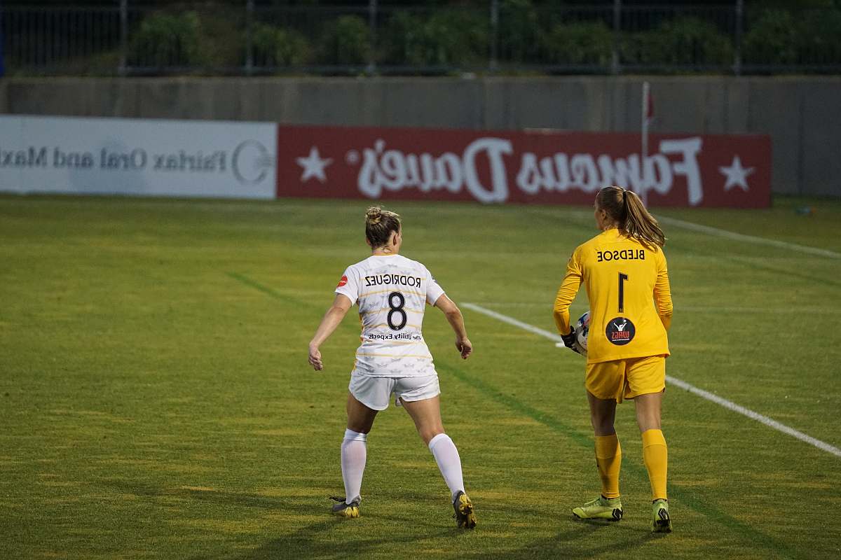 person two female players on field people