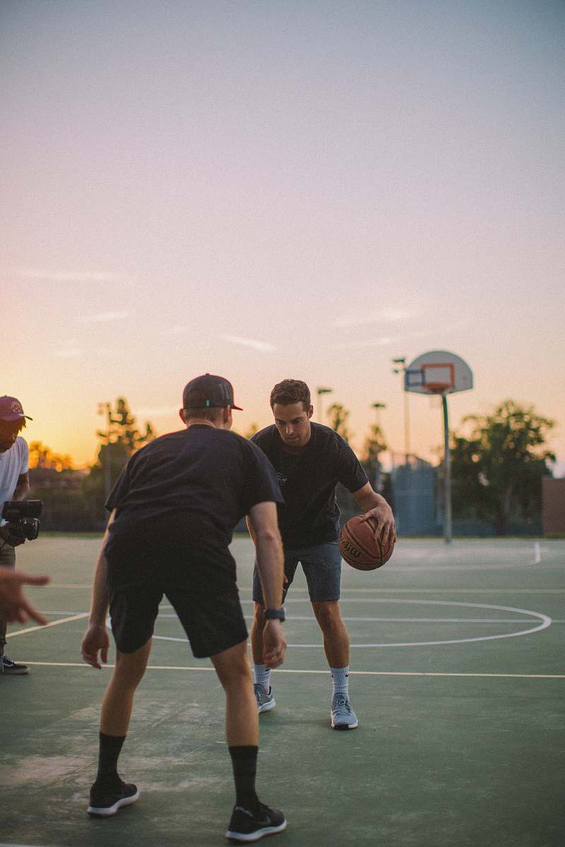 person two guy playing basketball during daytime people