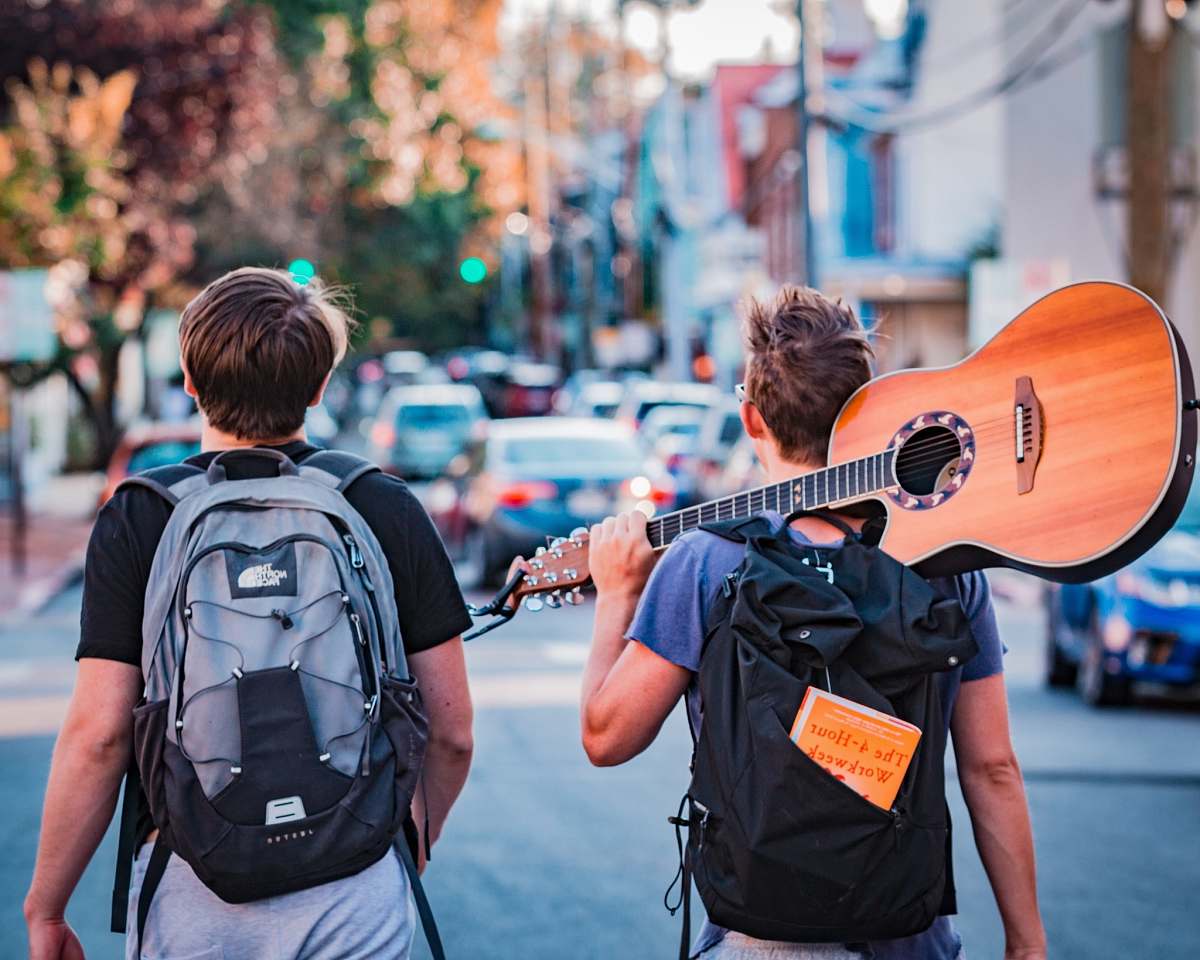 person two man carrying backpacks during daytime people