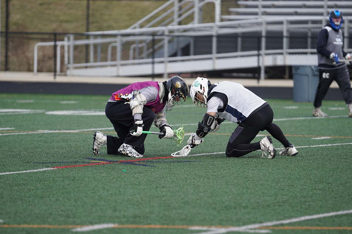 person two men playing lacrosse sports apparel