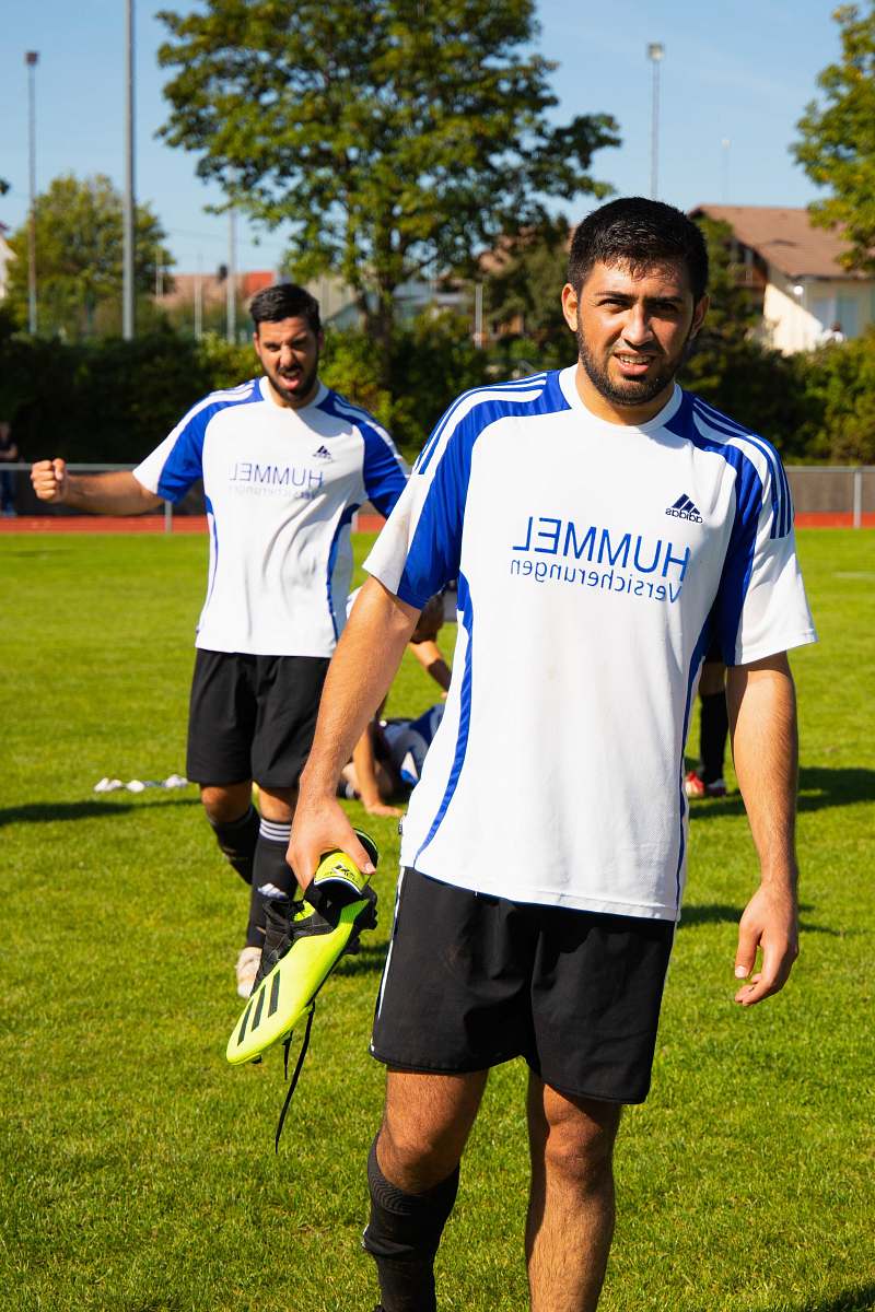 person two men standing in green field during daytime apparel
