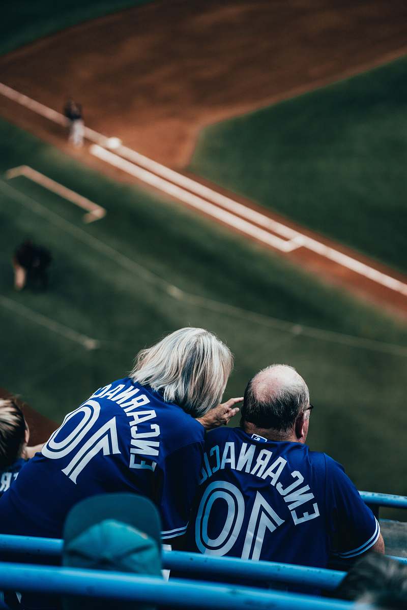 person two person in a baseball field during daytime clothing